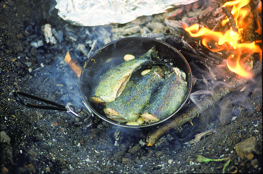 Photo by Nelson Kenter fish cooking trout outside bozeman